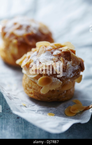 Fresh Choux pastry with creme and almonds Stock Photo