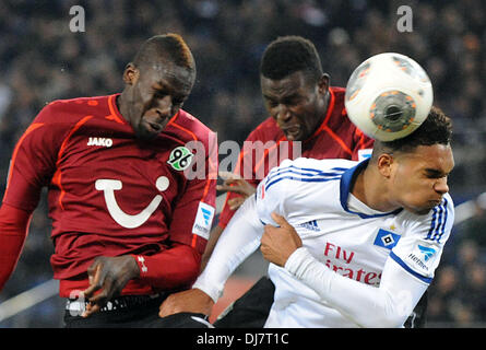 Hamburg, Germany. 24th Nov, 2013. Hamburg's Jonathan Tah (R) vies for the ball with Hanover's Salif Sane (L) and Mame Diouf during the German Bundesliga match between Hamburger SV and Hannover 96 at Imtech Arena in Hamburg, Germany, 24 November 2013. Photo: PETER STEFFEN (ATTENTION: Due to the accreditation guidelines, the DFL only permits the publication and utilisation of up to 15 pictures per match on the internet and in online media during the match.)/dpa/Alamy Live News Stock Photo