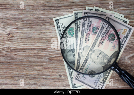 dollar banknotes under looking glass Stock Photo