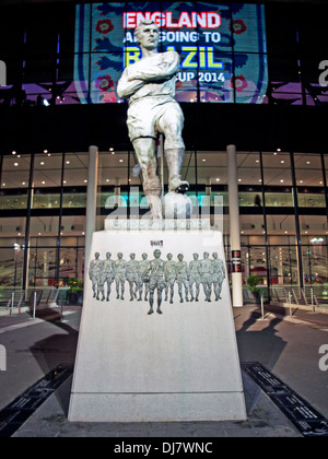 Sir Bobby Moore statue in front of Wembley Stadium at night, Wembley, London, England, United Kingdom Stock Photo