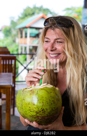 coconut woman drinking fresh water alamy vieng vang laos