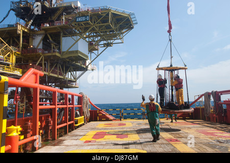 vessel able seaman or marine crew working on deck for platform crew transfer using safety basket Stock Photo