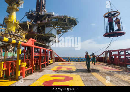 offshore vessel crew working on deck for transfer platform crew to vessel by personal basket Stock Photo