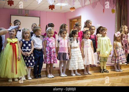 Russian children kindergarten. Kids singing the songs from the stage for parents. Russia Stock Photo