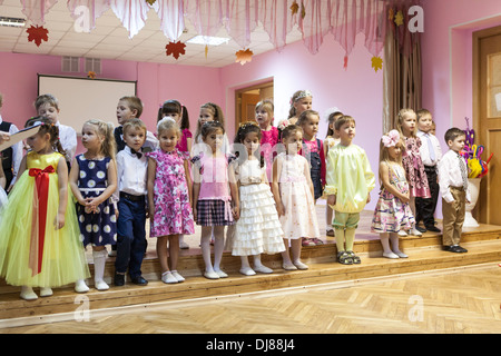 Russian children kindergarten. Kids singing the songs from the stage for parents. Russia Stock Photo