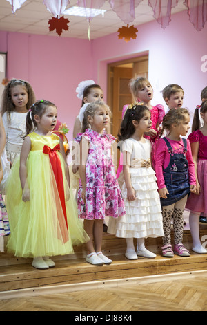 Russian children kindergarten. Kids singing the songs from the stage for parents. Russia Stock Photo