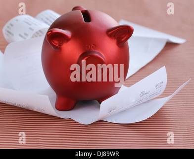 funny red Pig Piggy with lots of receipt - saving concept Stock Photo