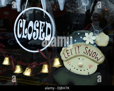 Closed shop with let it snow sign UK Stock Photo