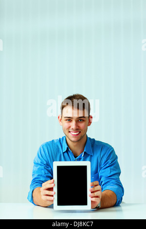 Young businessman showing display of tablet computer Stock Photo