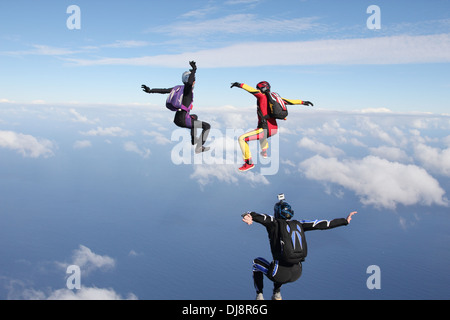 This freefly skydive team is training together for the next competition. It is fun for all to fly free over the clouds. Stock Photo