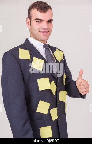 Businessman with covered in sticky notelets Stock Photo