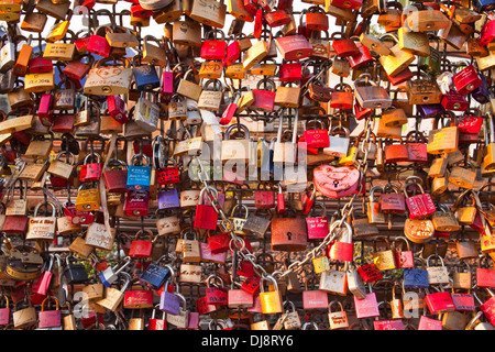 Love locks tied onto the railway bridge in Cologne. Stock Photo