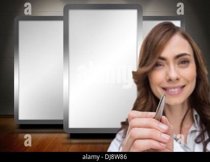 Smiling doctor holding pen Stock Photo