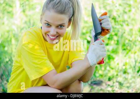 young pretty woman in her garden Stock Photo