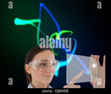Doctor in protective glasses holding virtual screen Stock Photo