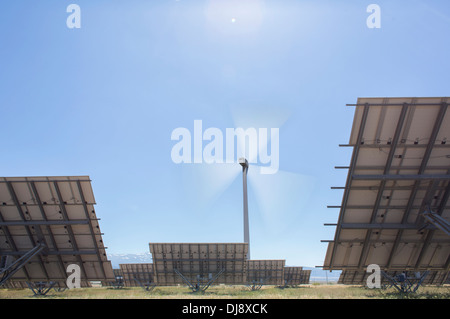 Wind turbine and solar panels in rural landscape Stock Photo