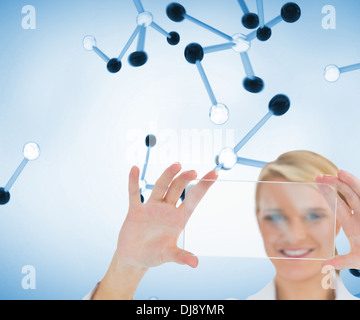 Doctor holding up clear pane and smiling Stock Photo