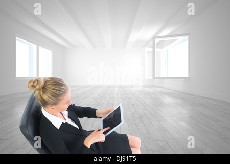 Composite image of businesswoman sitting on swivel chair with tablet Stock Photo