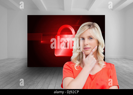Composite image of teenager standing upright thoughtfully with her fingers on her chin Stock Photo