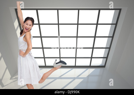 Composite image of happy and classy brunette posing Stock Photo