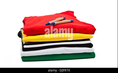 a stack of colorful t shirts and ballpoint pens Stock Photo