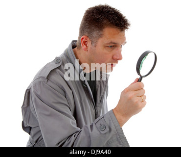 Man with raincoat is looking with magnifying glass over white background Stock Photo