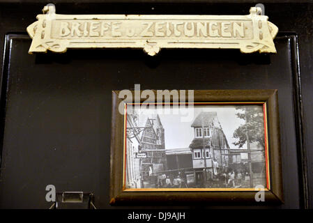 Eisenach, Germany. 07th Nov, 2013. A historical photo hangs in the 'Narrow House' in Eisenach, Germany, 07 November 2013. With a width of 2.05 meters, the about 250 year old house is likely to be the narrowest occupied half-timber house of Germany. © dpa/Alamy Live News Stock Photo