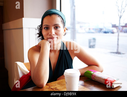 Mixed race woman sitting in cafe