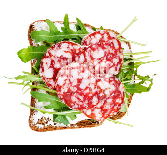 sandwich from rye bread, soft cheese, salami and fresh arugula isolated on white background Stock Photo