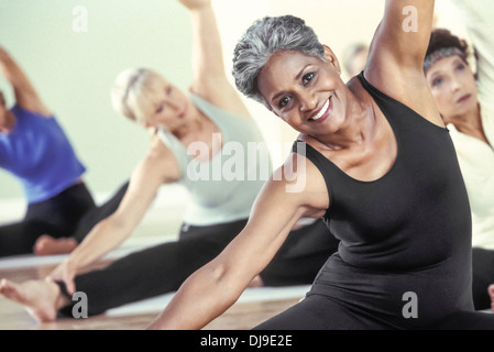 Older women stretching in yoga class Stock Photo