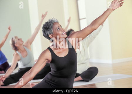 Older women stretching in yoga class Stock Photo