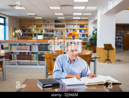 Man reading in library Stock Photo