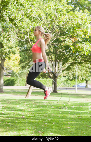 Side view of sporty woman skipping Stock Photo