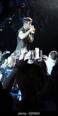 Joey McIntyre of New Kids On The Block getting a beer from a member of the audience whilst performing live at O2 Arena. Hamburg, Germany - 09.05.2012 Stock Photo