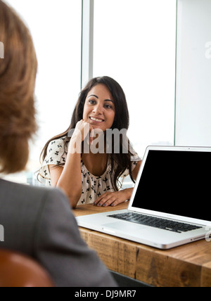 Businesswomen talking in office Stock Photo