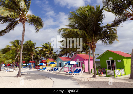 Colorful beach huts front the Caribbean Sea on the Bahamian Island of Eleuthera Stock Photo