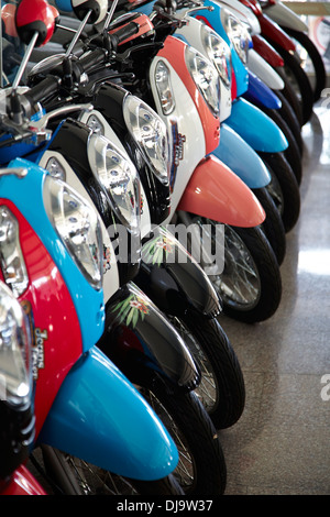 Motorcycle motorbike showroom showing all the range of scooters on sale in Korat, Thailand Stock Photo