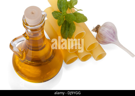 Cannelloni with olive oil in a glass bottle, fresh basil and garlic isolated on white background Stock Photo