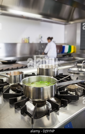 Several pots cooking on hotplate Stock Photo