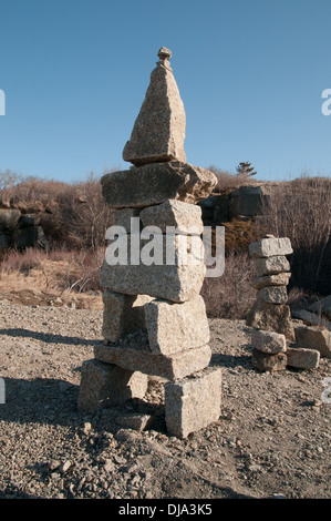 Visitors to Halibut Point in Rockport, MA make cairns and free-form sculpture from the abundant chunks of granite. Stock Photo