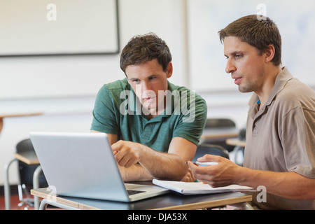 Two concentrated handsome mature students sitting in class Stock Photo