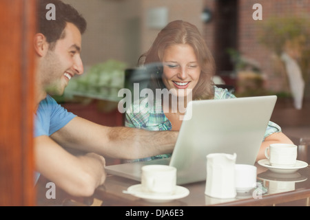 Two laughing students looking at laptop Stock Photo