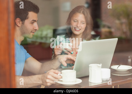 Two laughing students working at laptop Stock Photo