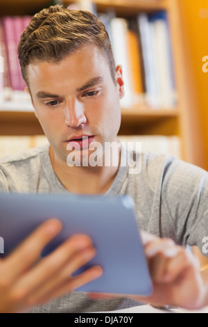 Attractive focused student using tablet Stock Photo