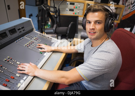 Handsome smiling radio host moderating Stock Photo