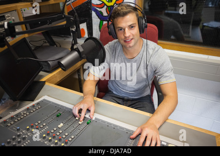 Handsome cheerful radio host moderating Stock Photo