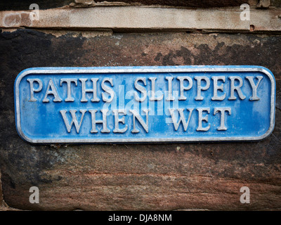 Paths slippery when wet sign uk Stock Photo