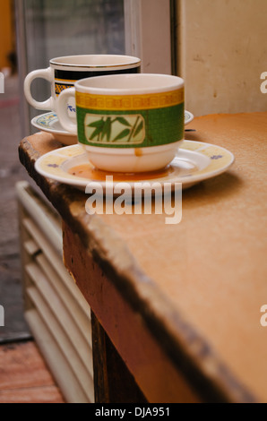 Two empty cups of coffee on a table outside a restaurant in Deira. Dubai, United Arab Emirates. Stock Photo