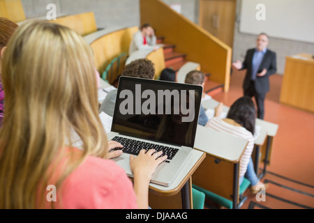Teacher and students using laptop in science center Stock Photo - Alamy