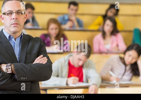 Portrait of an elegant teacher with students at lecture hall Stock Photo